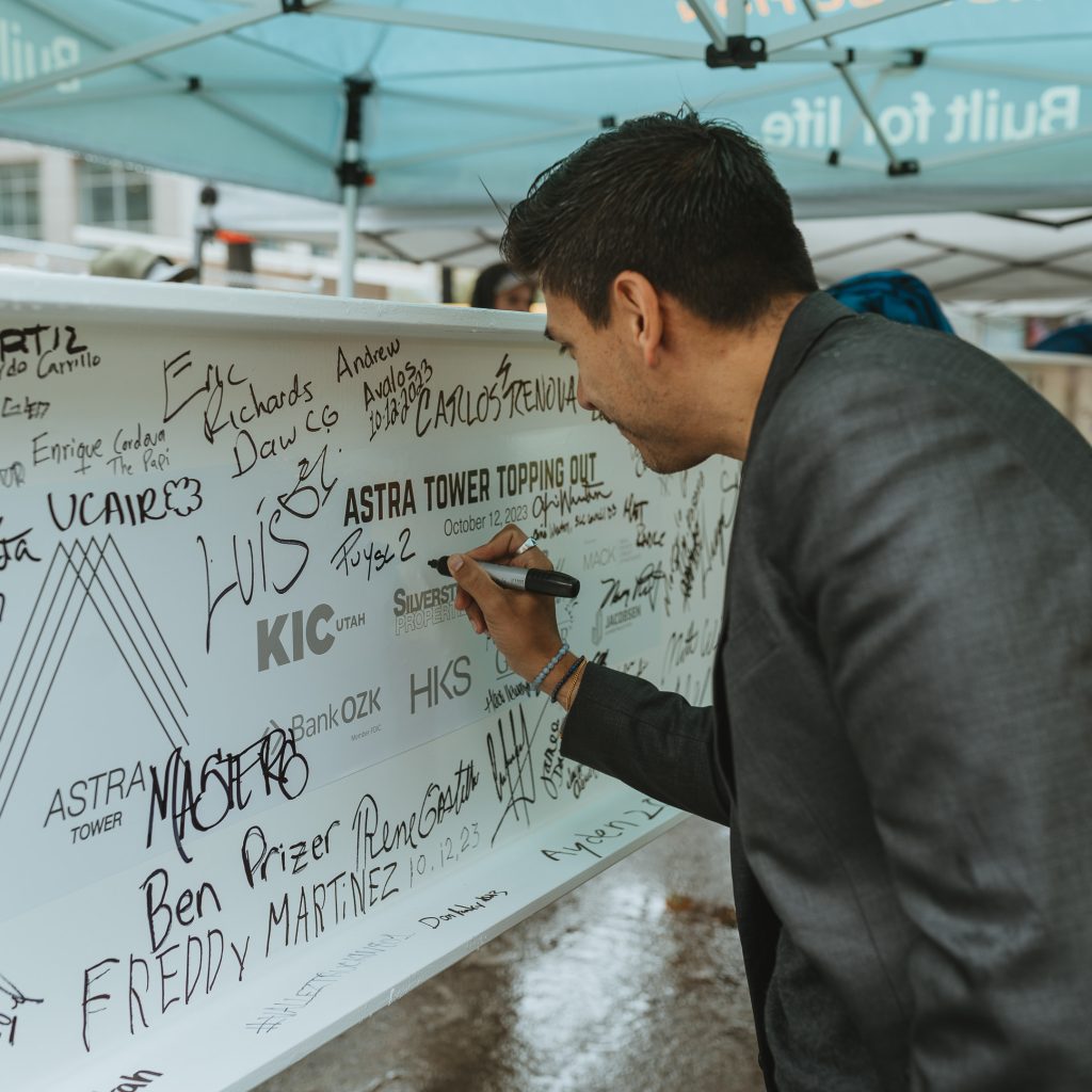 District 2 Council Member Puy signing the last Astra Tower beam.