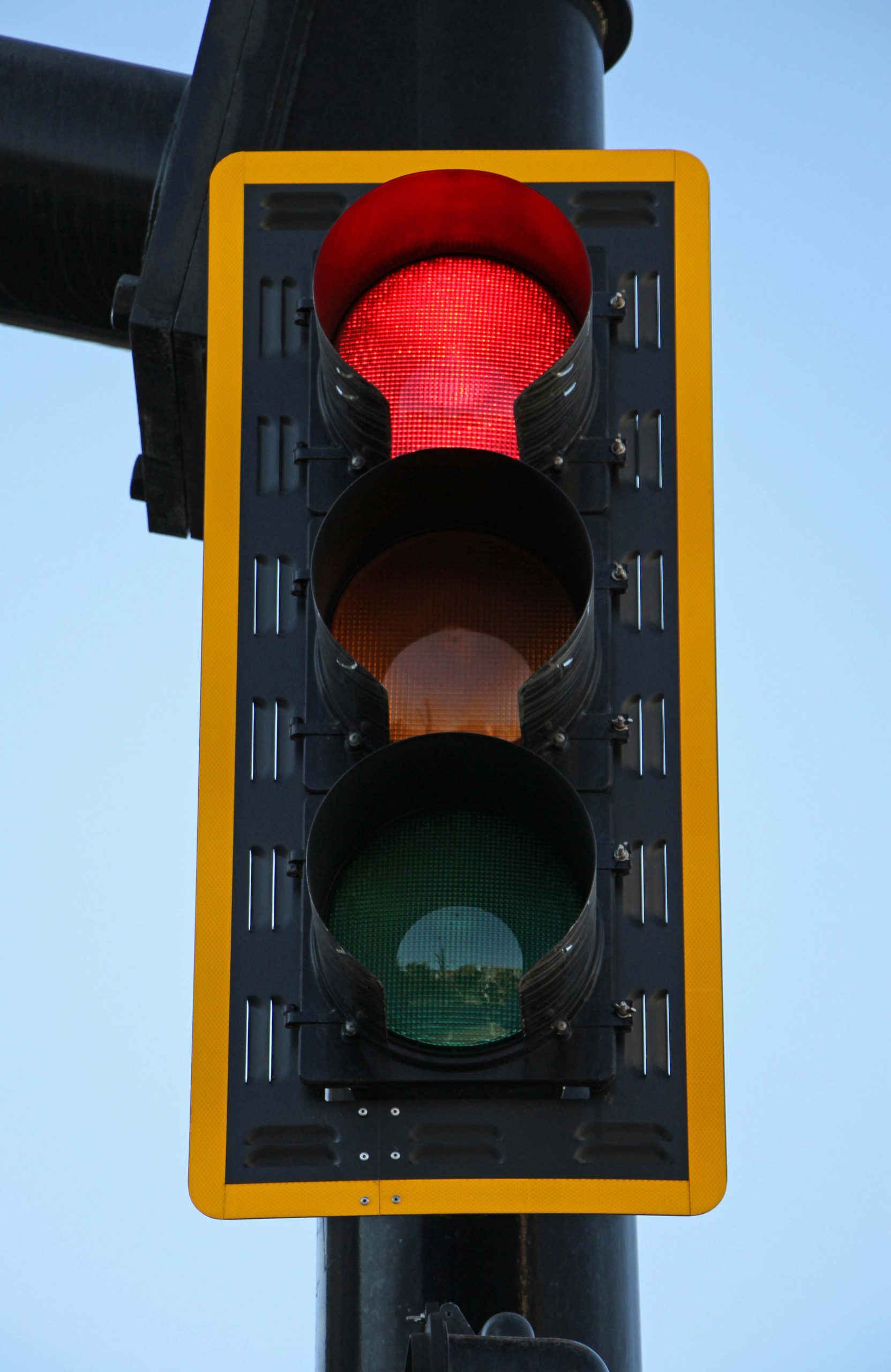 Close up view of a three head traffic signal.