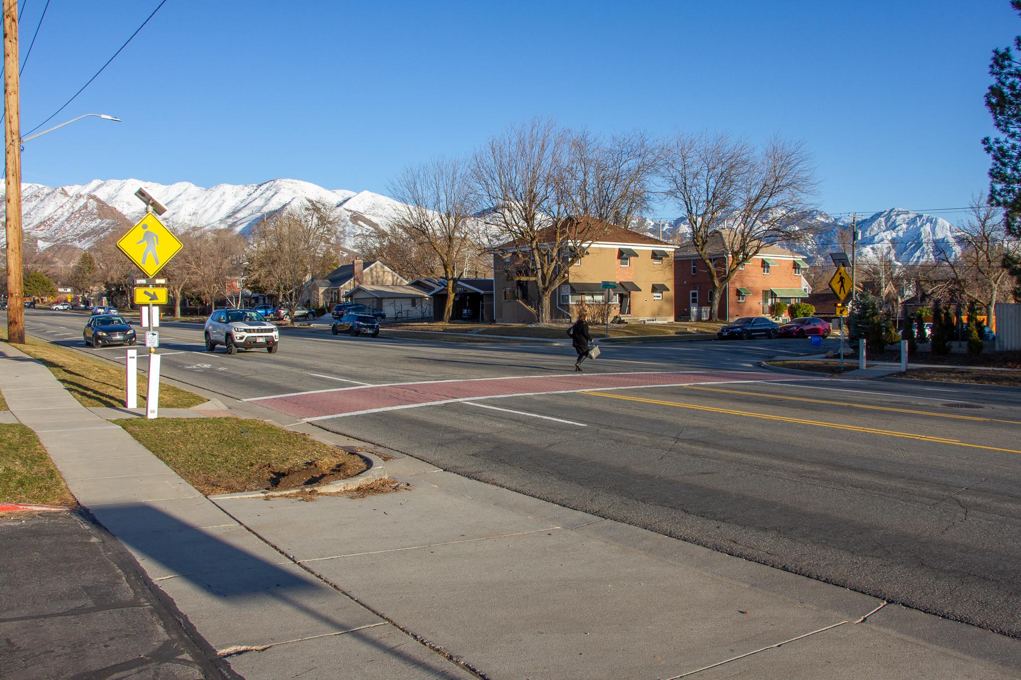 A photo of a person crossing Sunnyside Ave.