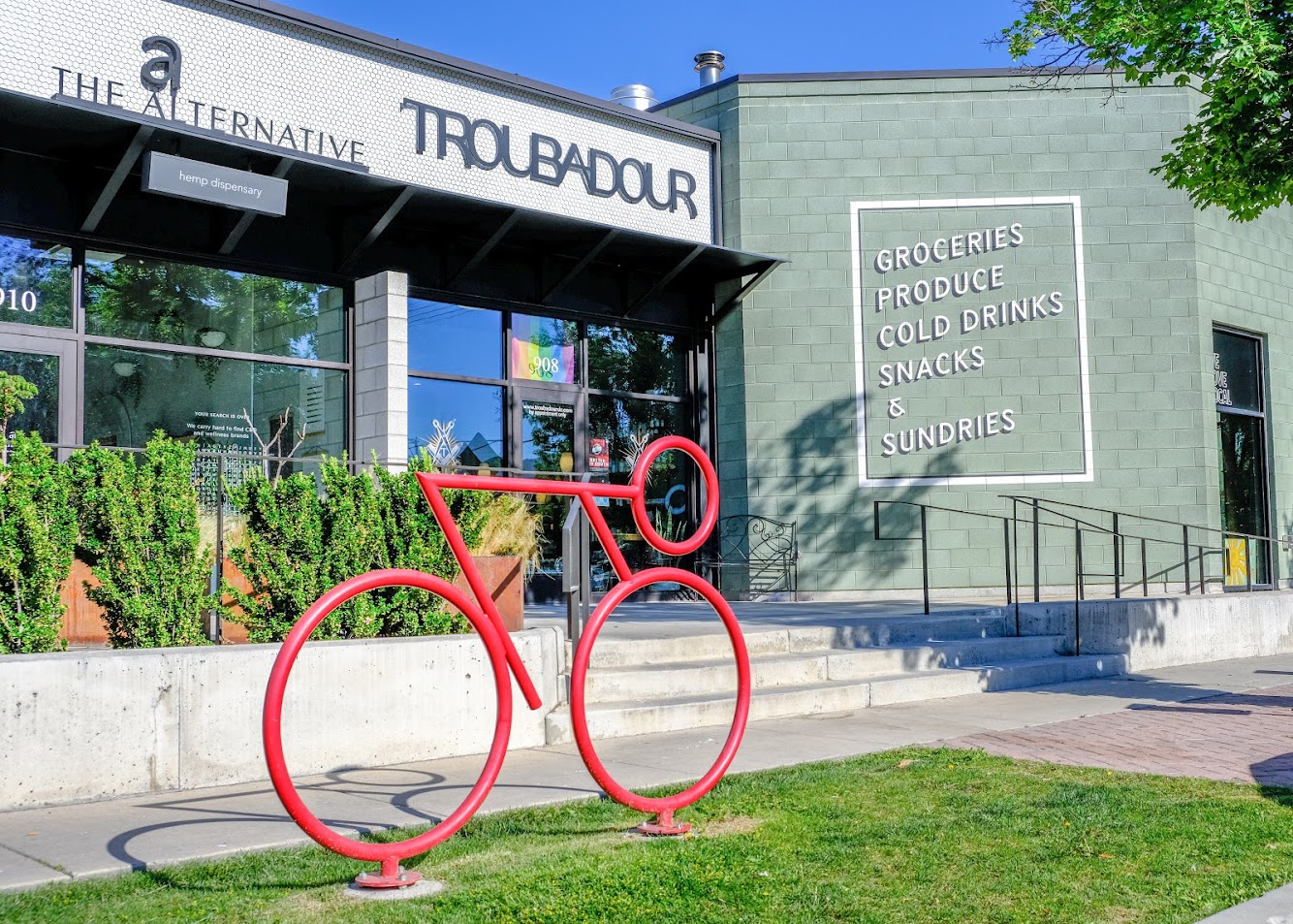 A photo of a red bicycle-shaped bike rack.