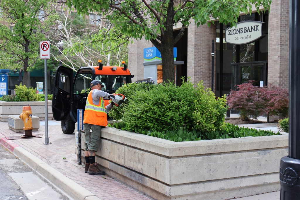 City employee performing landscaping duties in downtown Salt Lake City.