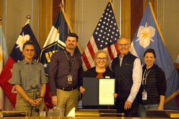 Salt Lake City Council members and staff stand with the Mayor Mendenhall holding a proclamation recognizing March as National Women’s History Month.