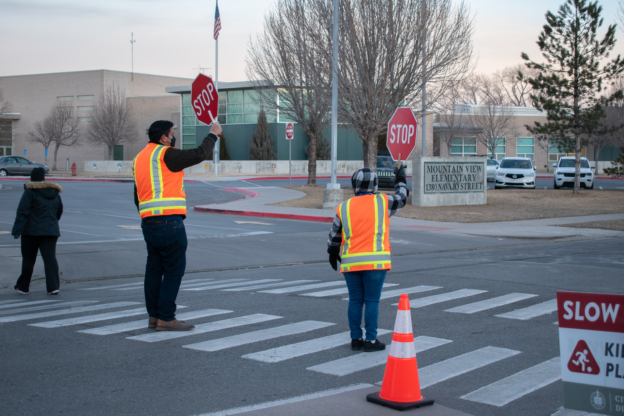 Council Member Puy stops traffic for a pedestrian with one of our crossing guards.