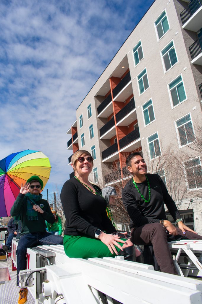 Council Member Alejandro Puy and other Salt Lake City Council Members riding a fire truck during 46th annual St. Patrick's Day Parade