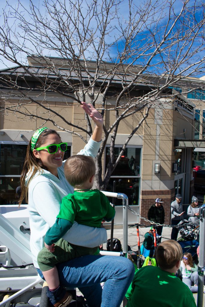 District 4 Council Member Ana Valdemoros and her son waving at the people watching the parade.