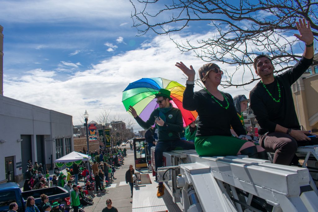 Council Member Alejandro Puy and other Salt Lake City Council Members on the top of a fire truck waving at the crowd.