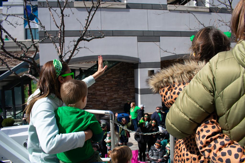 District 4 Council Member Ana Valdemoros and her son waving at the crowd.