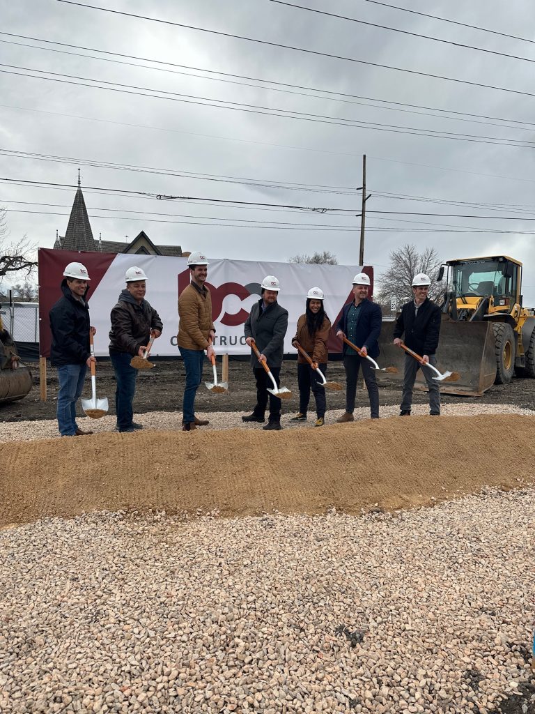 6 bcc construction employees shoveling the first dirt for the ground breaking. 