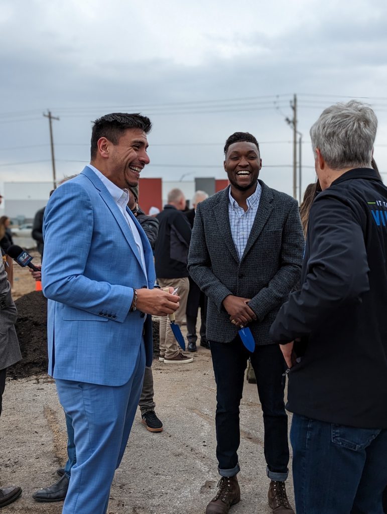 Council Member Alejandro Puy talking with people at the ceremony.