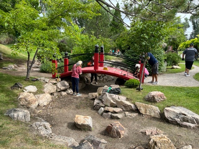 People painting the red bridge.