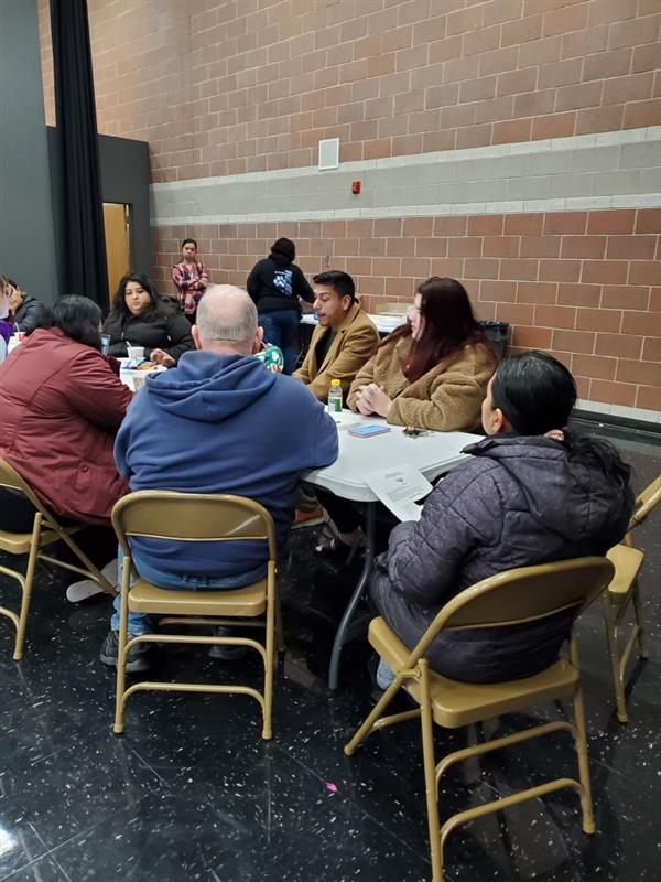 Close view of District 2 Council Member Alejandro Puy sitting at a table with the Parkview Elementary School Community Council.