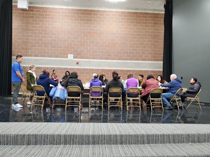 Wide view of District 2 Council Member Alejandro Puy sitting at a table with the Parkview Elementary School Community Council.