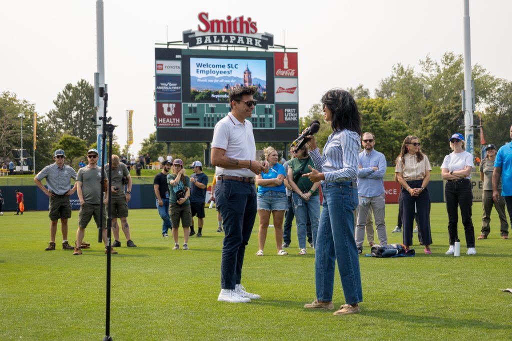 Woman and man speaking to crowd.