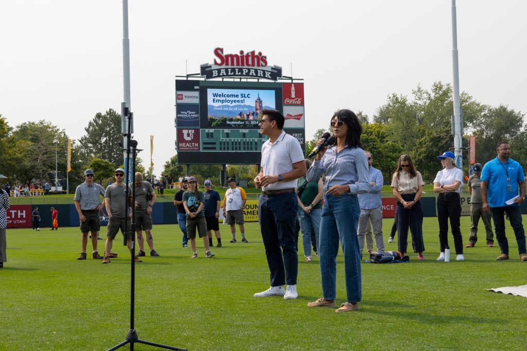 Woman and man speaking to crowd.