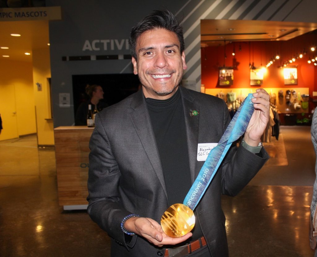 Council Member Puy holding an olympic gold medal