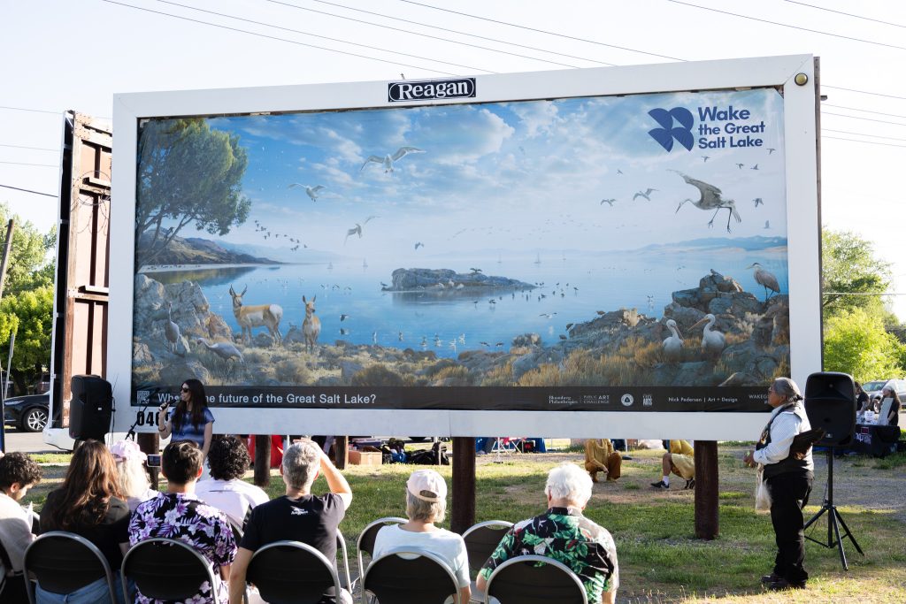 Crowd looking at billboard.
