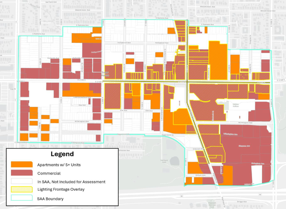 Long Description:
The image is a map indicating various areas within a set boundary, marked by a light blue line. The map uses different colors to represent specific types of zones. Dark red areas depict apartments with five or more units, while orange areas indicate commercial zones. White sections with a faint yellow outline show regions not included for assessment. There is a yellow line overlay representing lighting frontage. Roads and streets are subtly visible in the background, creating a grid-like pattern. At the bottom left is a legend box explaining the color codes and what each represents.
Alt-text:
Map showing areas within a boundary marked by color codes for apartments, commercial zones, and lighting frontage.