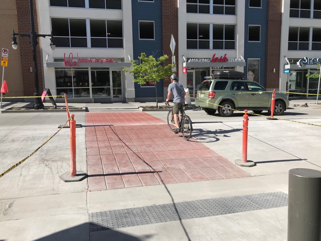 A person on a bicycle crossing Wilmington Avenue