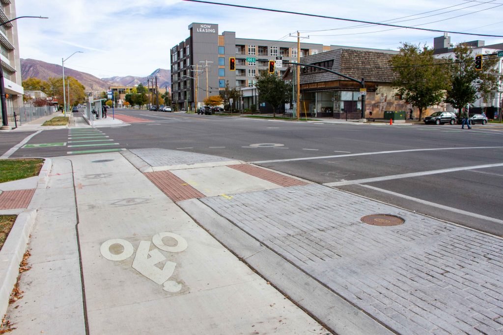 A picture of the bike lane on 200 South which is protected by a raised concrete curb at the intersections.
