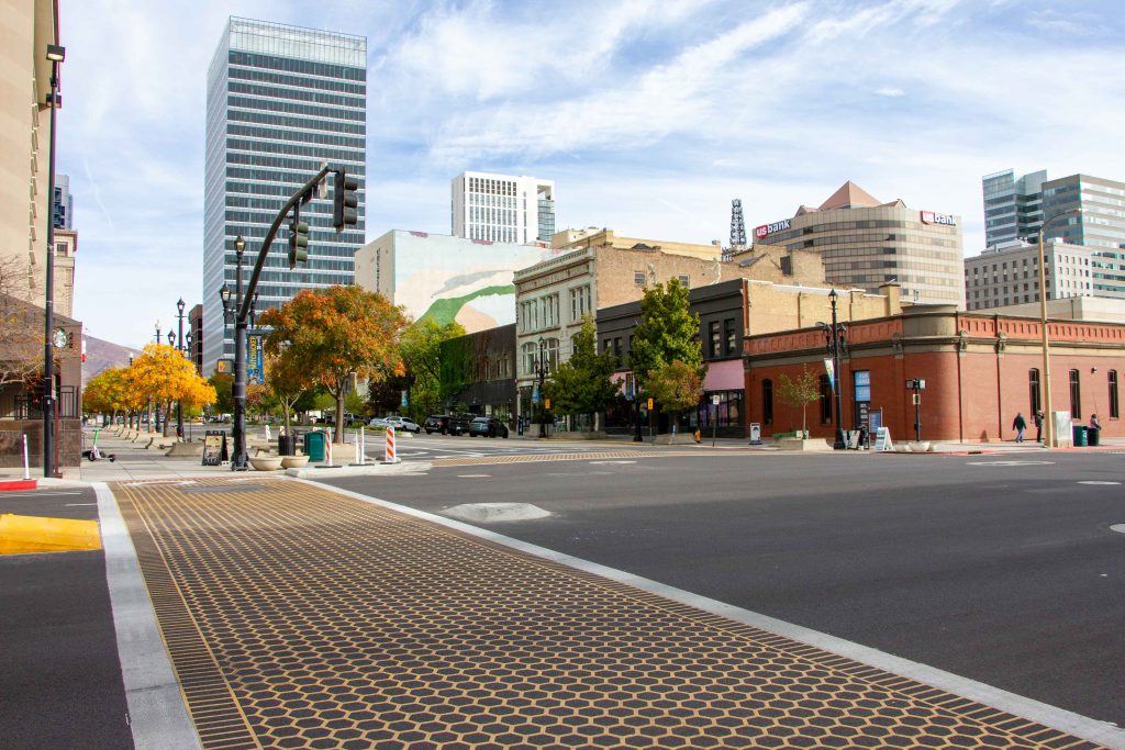 A picture of an artistic honeycomb crosswalk at the intersection of 100 South and West Temple. 