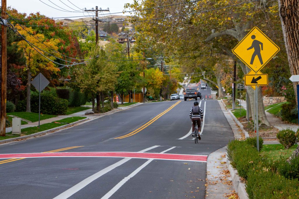 A picture of a person biking in a buffered bike lane up Virginia Street.