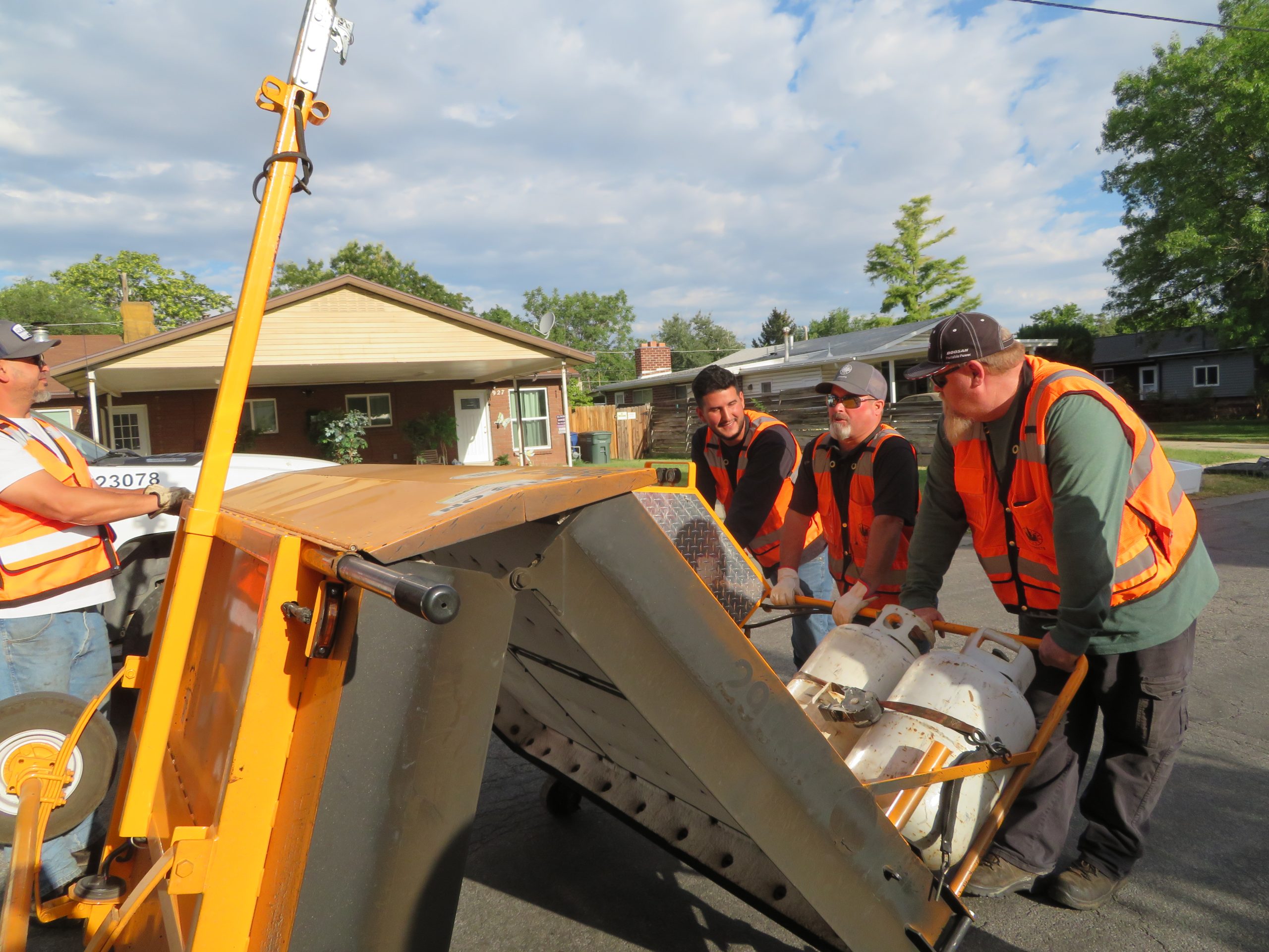 The infrared reclaimer, which is stored folded in half, as the crew rolls it to the spot of road to be repaired