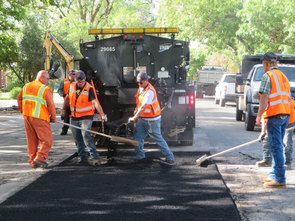 The repaired area filled with evenly spread asphalt