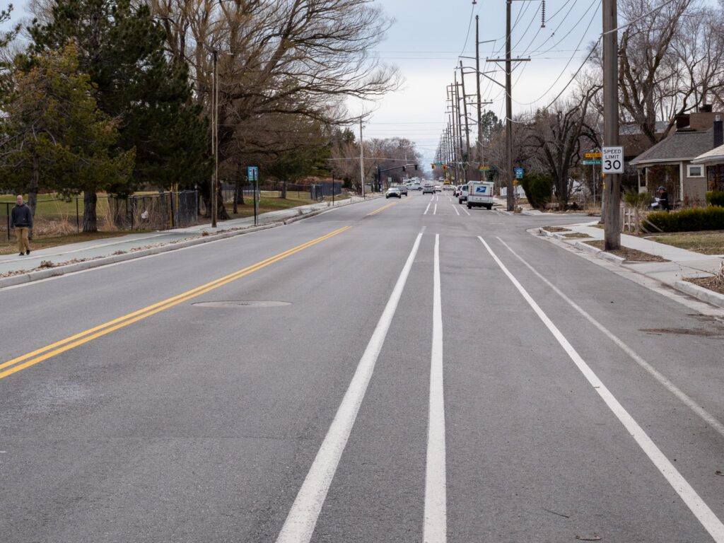 900 East after the reconstruction project. There is a southbound painted bike lane with a two foot buffer zone between the bike lane and the vehicle lane. There is a shared-use path on the east side of the street.