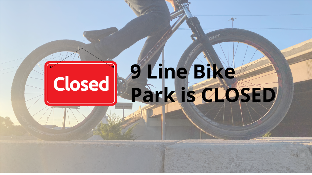Photo of a bicyclist with a closed sign.