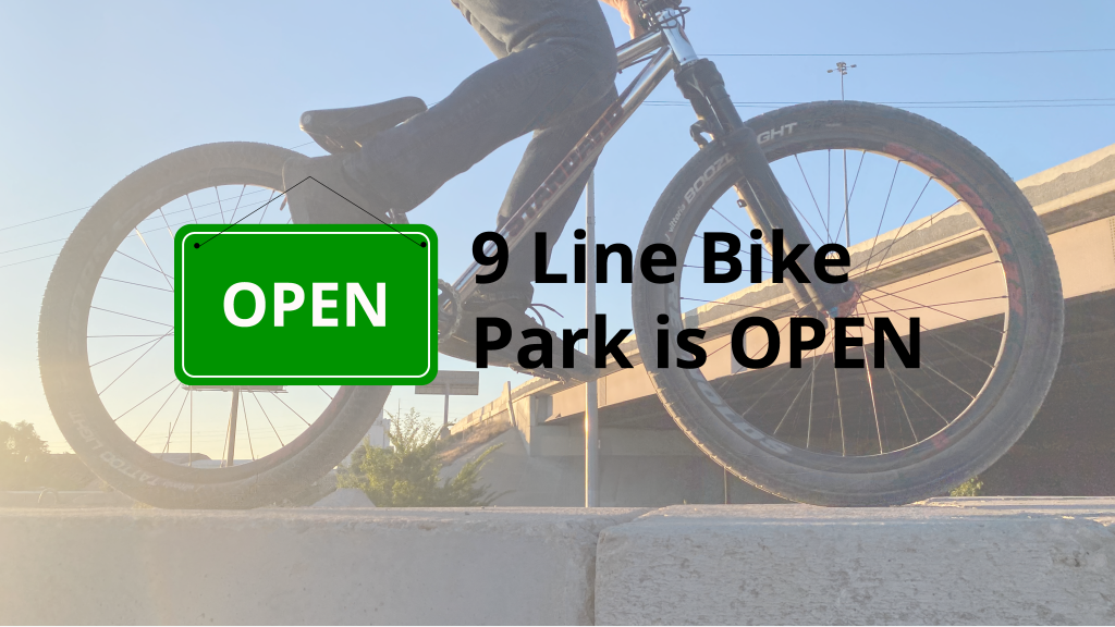 Photo of a bicyclist with an open sign.