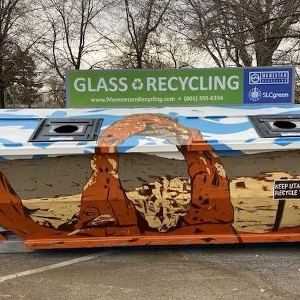 image of the glass recycling dropoff bin in the Tracy Aviary parking lot painted with an image of the delicate arch