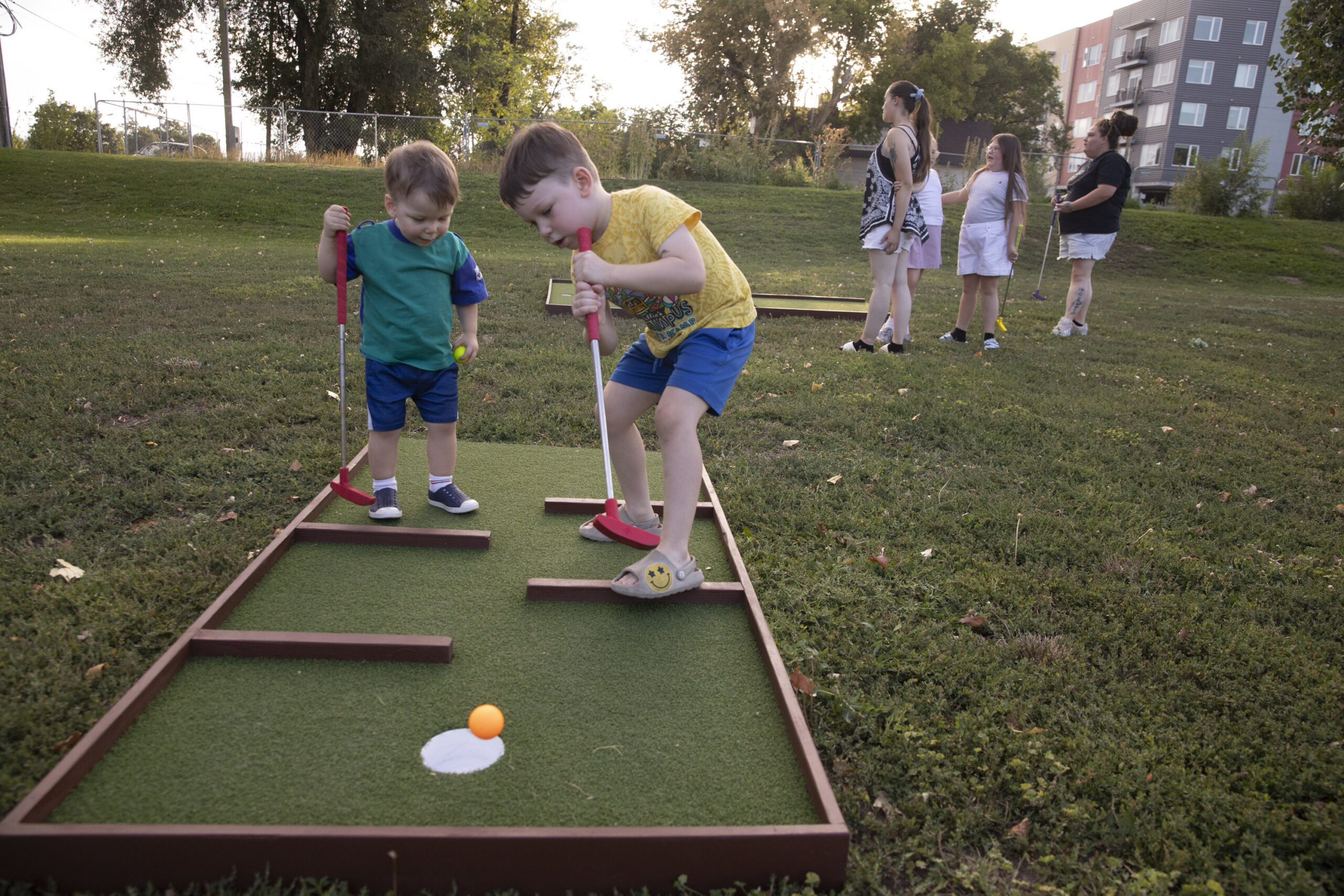 children playing mini golf