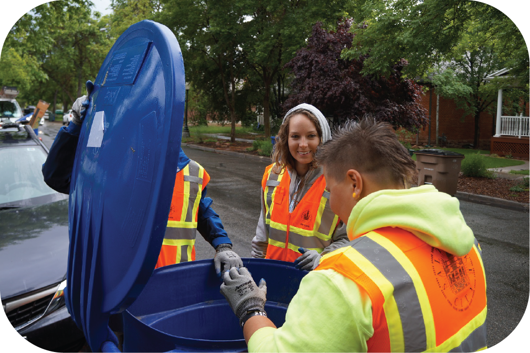 Master Recycler students checking blue bin during volunteer hours