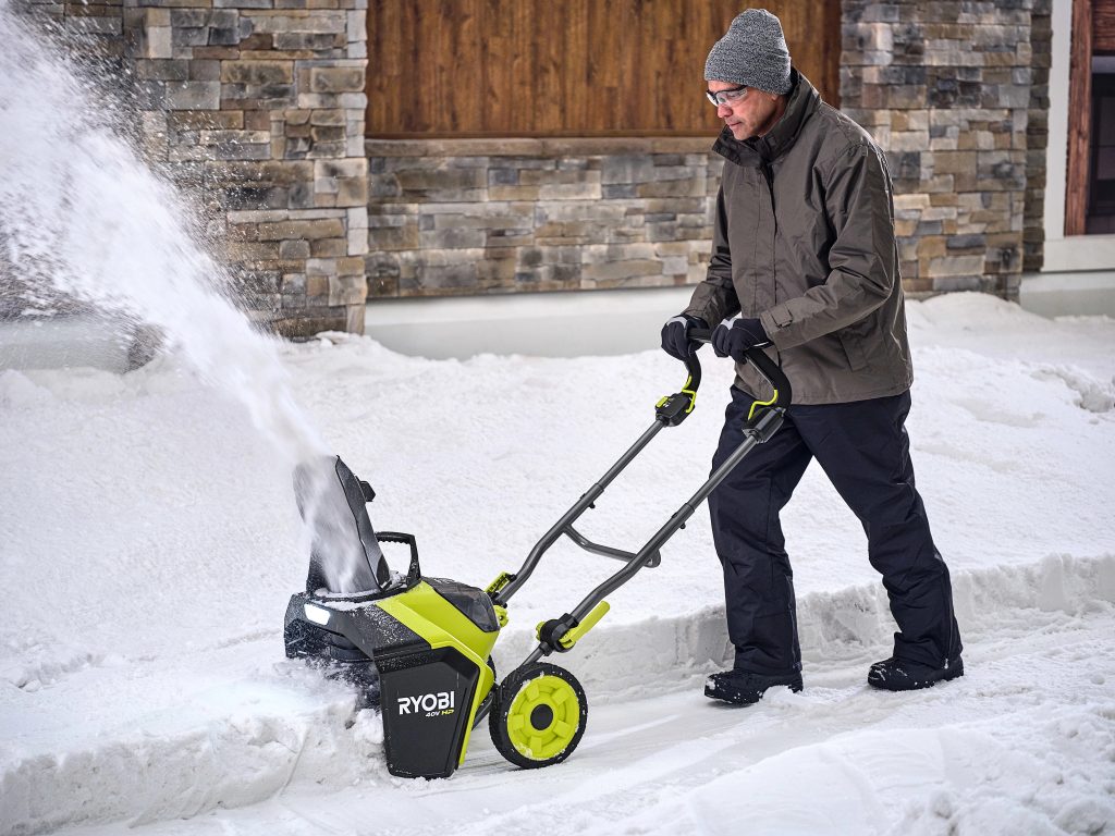 person using snow blower