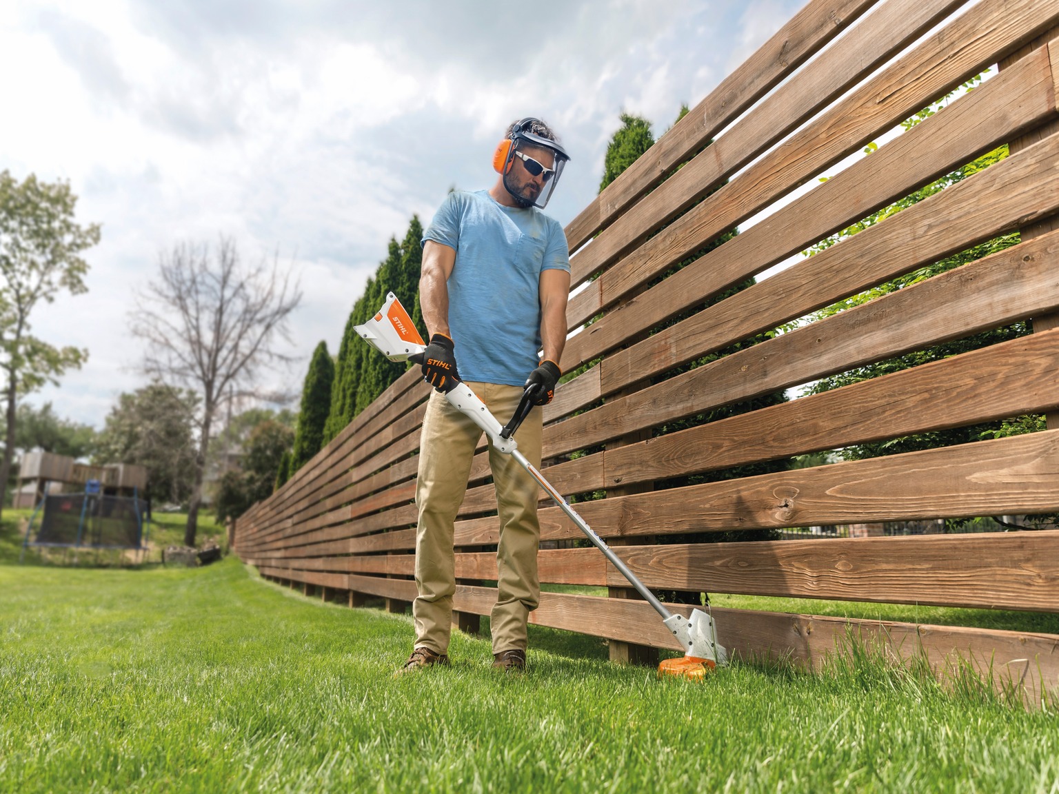 person using string trimmer