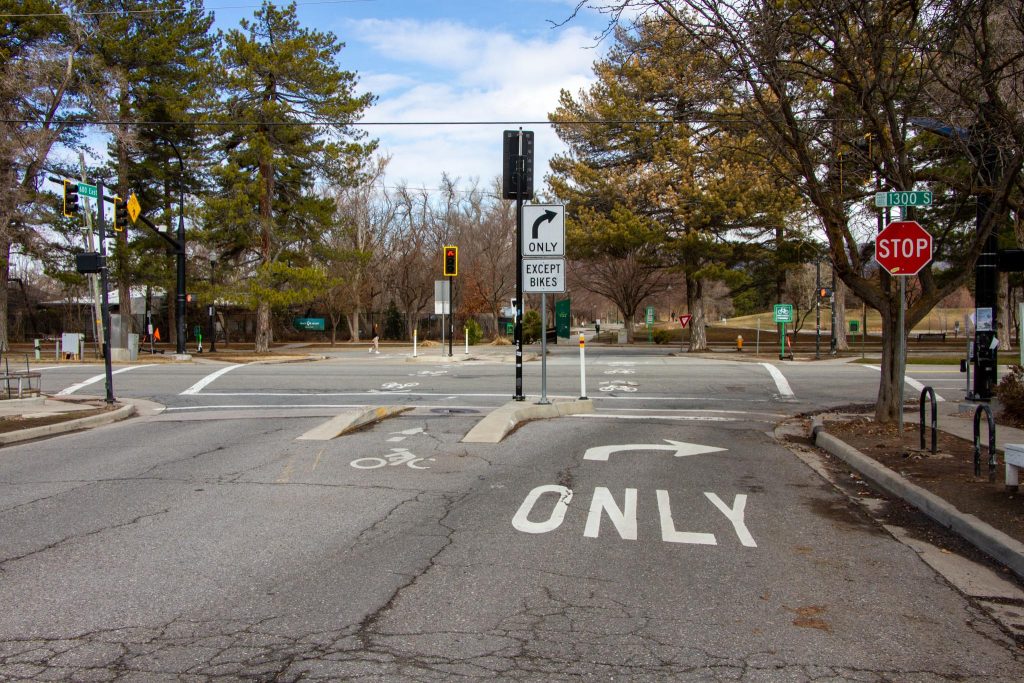 A "toucan" crossing at the intersection of 600 East and 1300 South. People walking and riding bicycles are allowed to go straight but vehicles are forced to turn right.