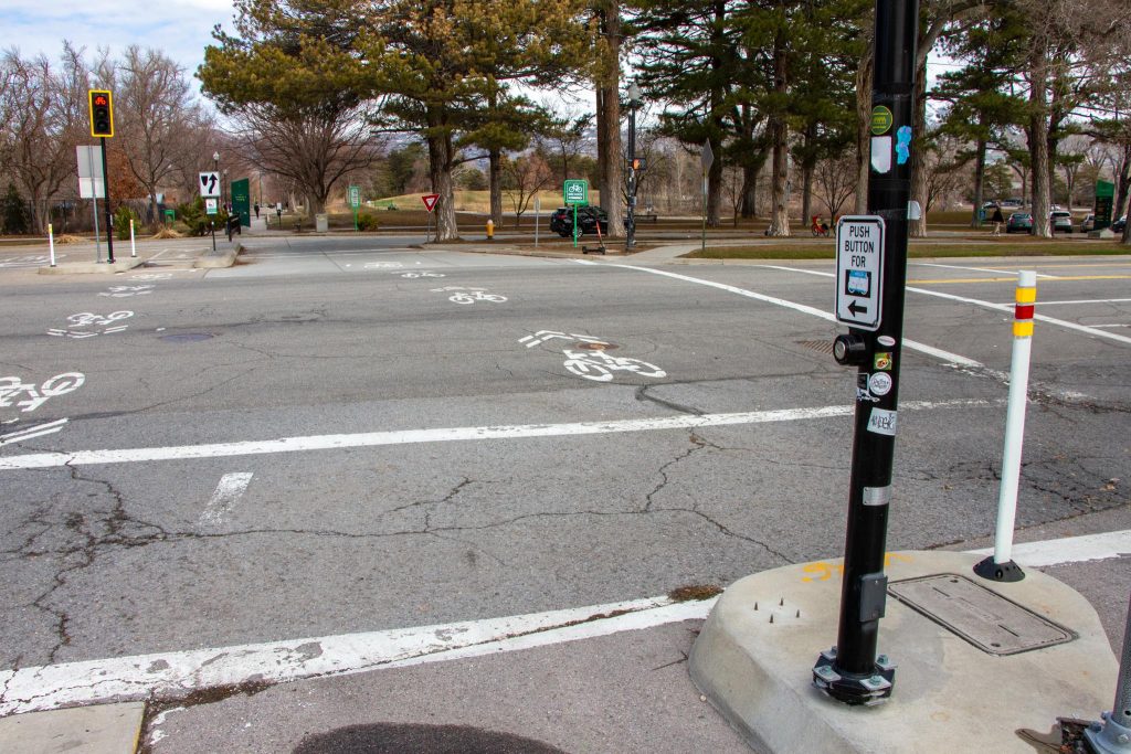 A push button located in the middle of 600 East at the intersection of 1300 South. This push button is designed to help bicyclists trigger a green light without having to use the pedestrian push button on the corner of the intersection. 