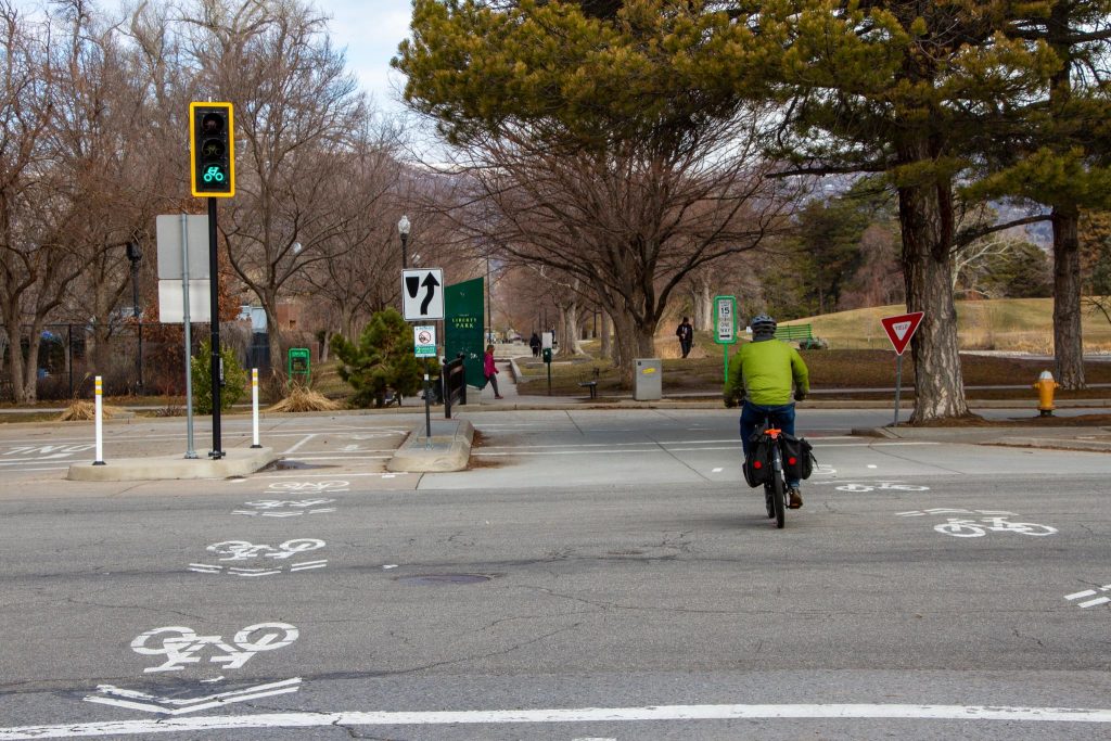 A person riding a bicycle into Liberty Park at 1300 South. 