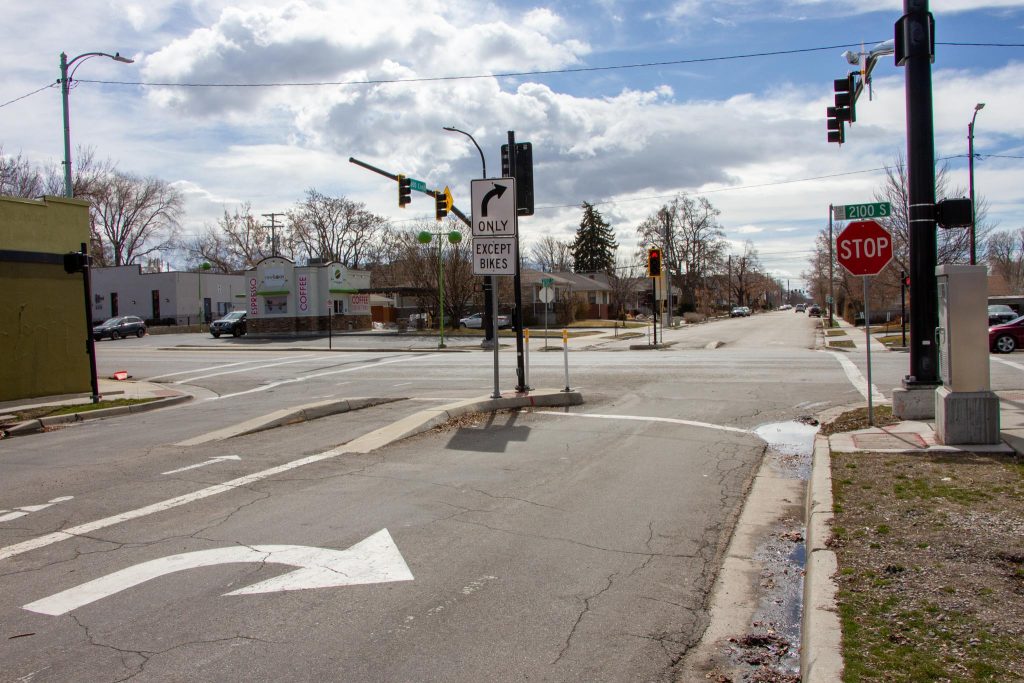 A "toucan" crossing at 600 East and 2100 South. People walking and riding bicycles are allowed to go straight but vehicles are forced to turn right.