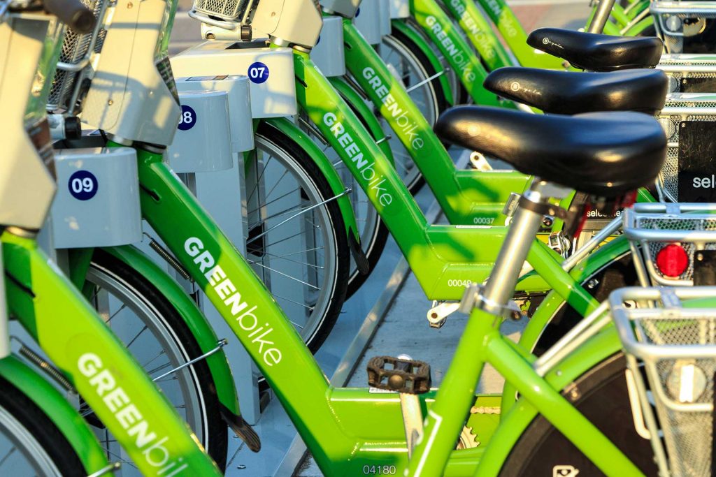 Row of bicycles parked at a Greenbike bike share station