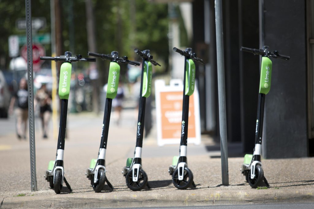 Row of Lime scooters on the sidewalk