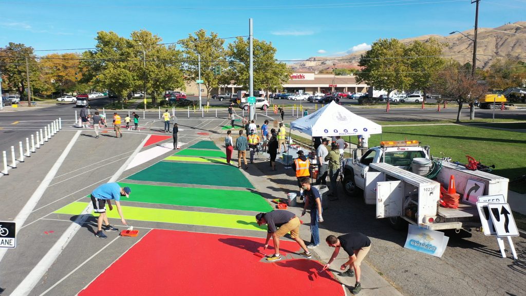 A picture of a group of people painting the asphalt near 600 North.