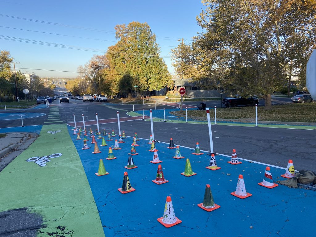 A picture of the quick build safety project at the intersection of 600 North and 200 West. The intersection was visually narrowed with colorful paint and delineator posts.