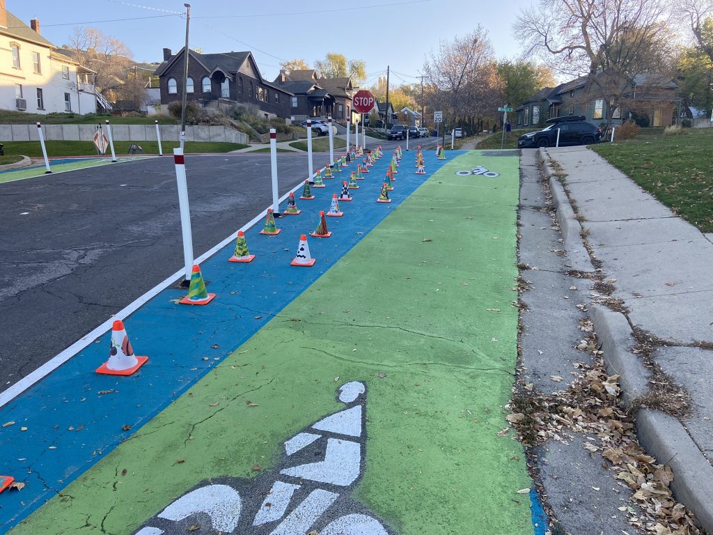 A picture of the quick build safety project at the intersection of 600 North and 200 West. The intersection was visually narrowed with colorful paint and delineator posts.
