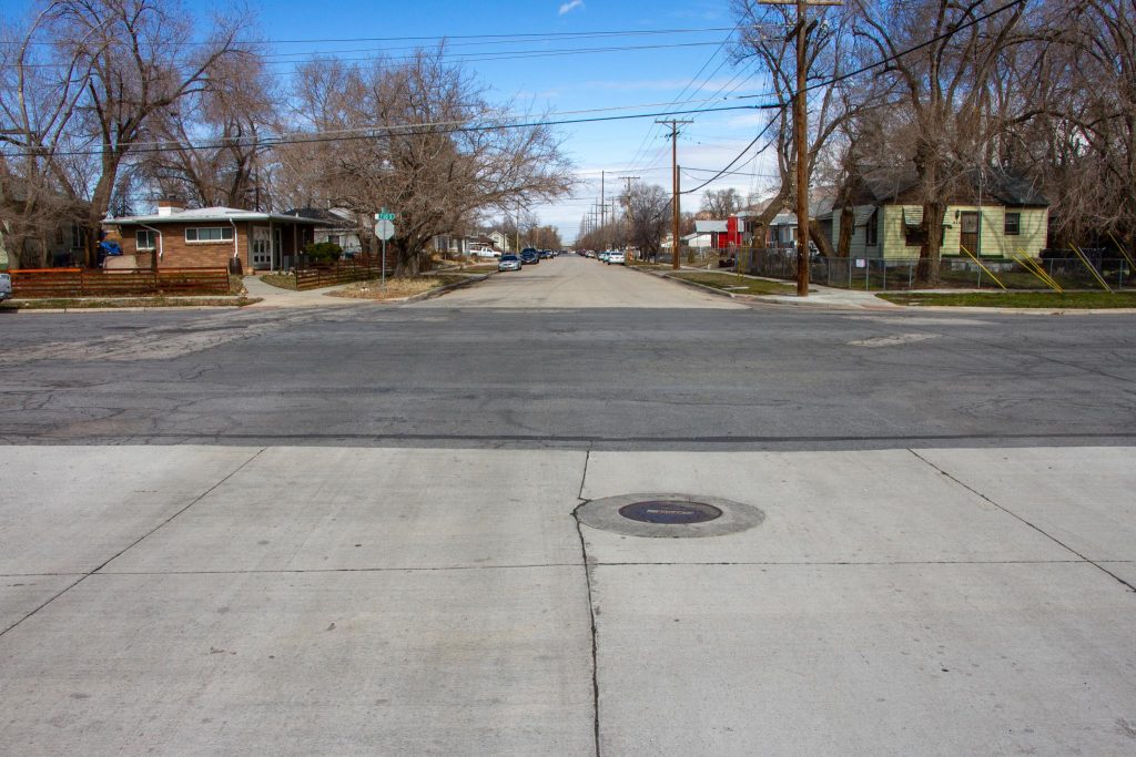 Existing conditions at the intersection of 1000 West and 700 South. A very wide street in a residential neighborhood.