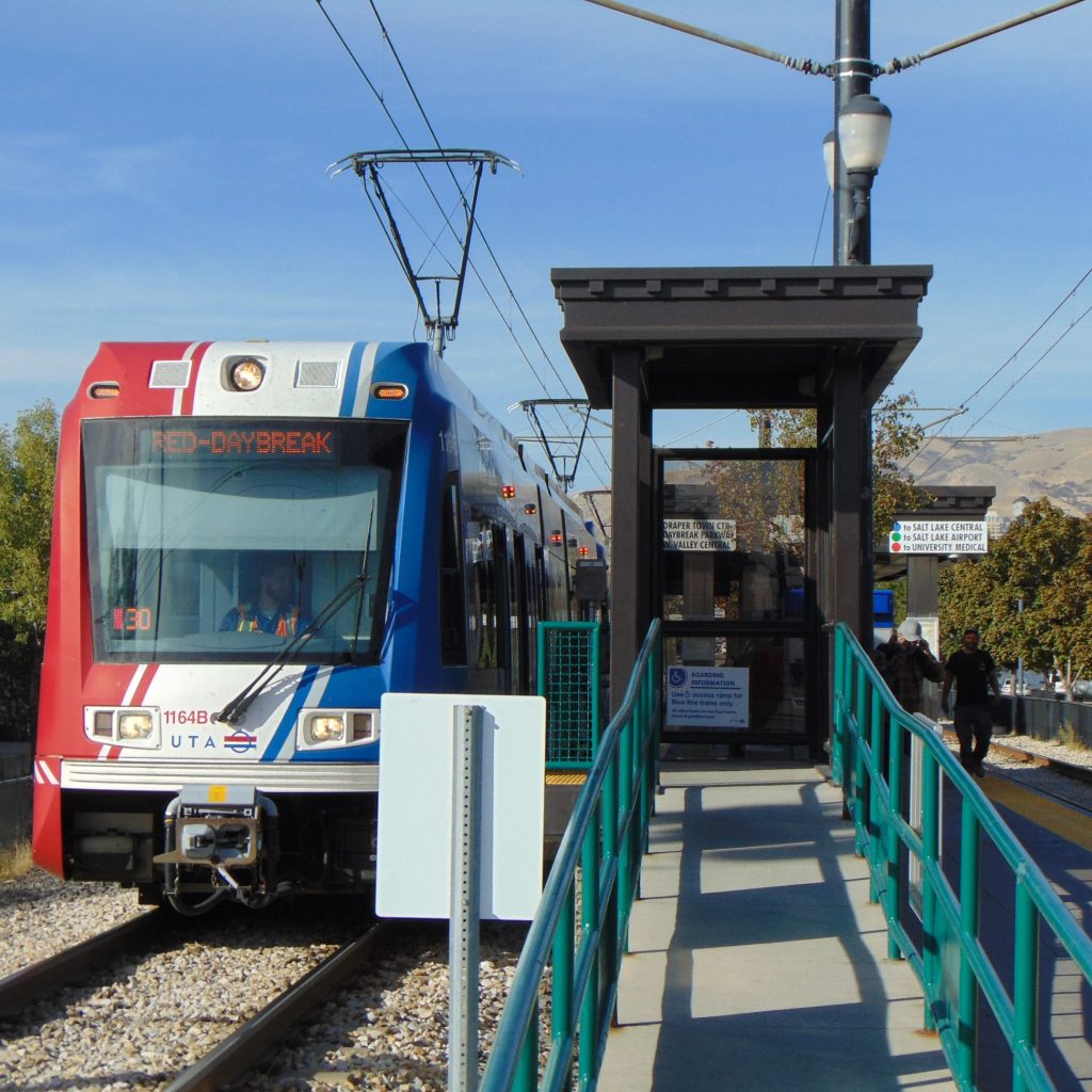 The TRAX Red Line stopped at a UTA train platform.