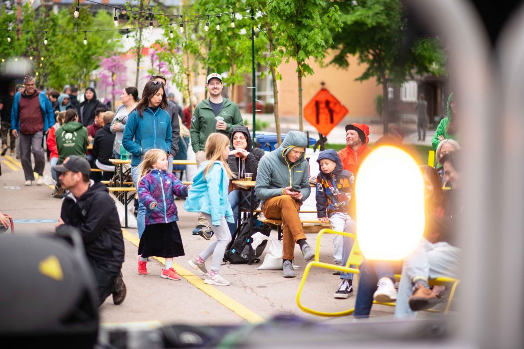 A group of people, both children and adults, enjoying music at the Green Loop.