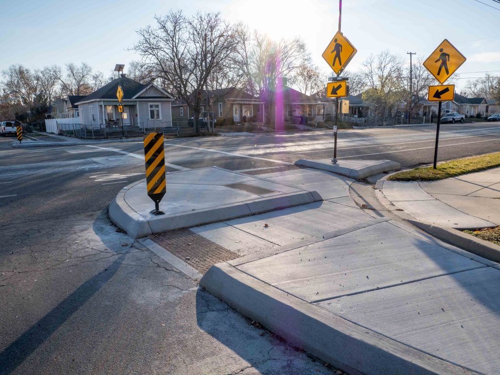 A picture of curb extensions and flashing crosswalk signs at a crossing on 400 South in Poplar Grove.