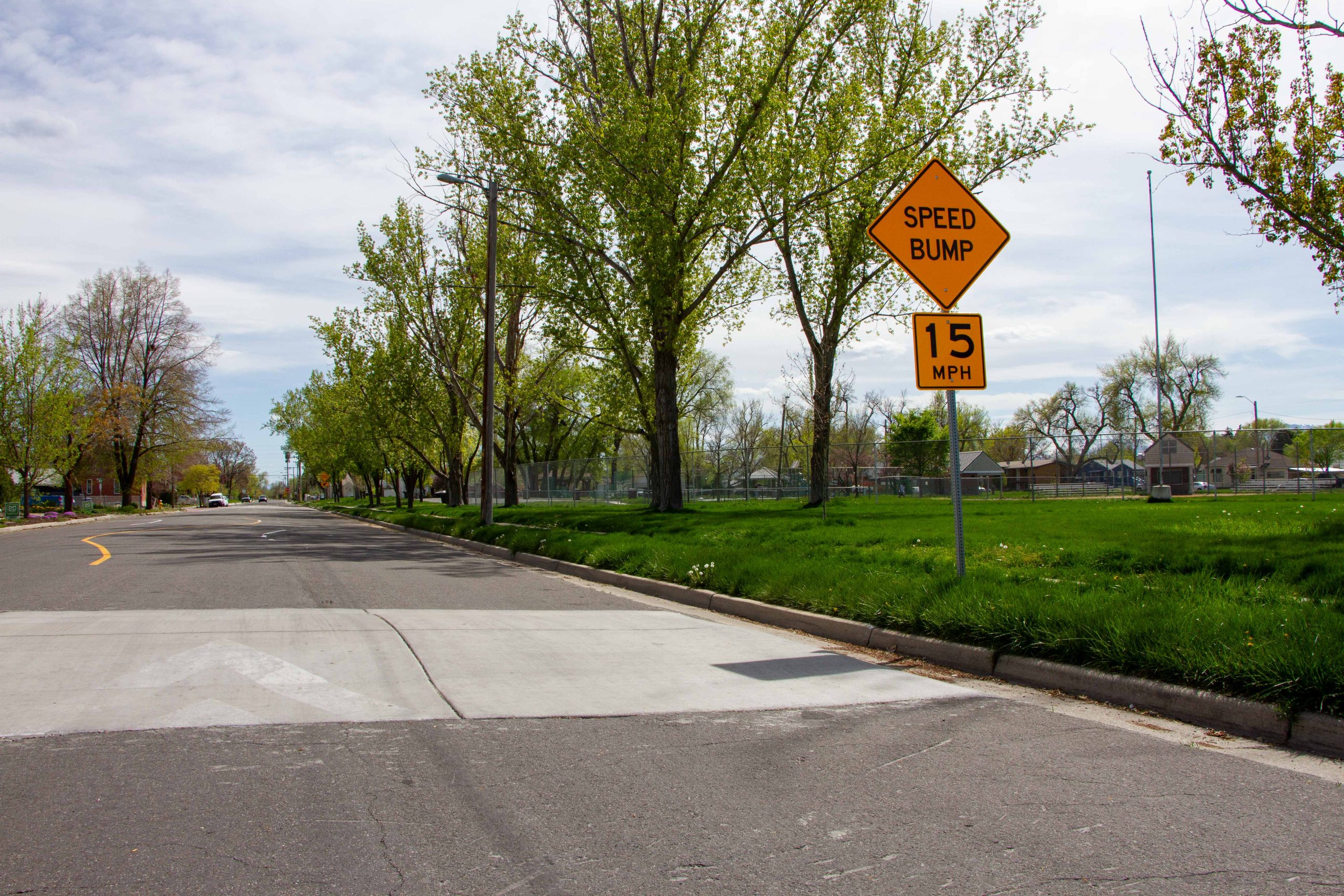A picture of a speed bump on Emery Street in front of Poplar Grove Park.